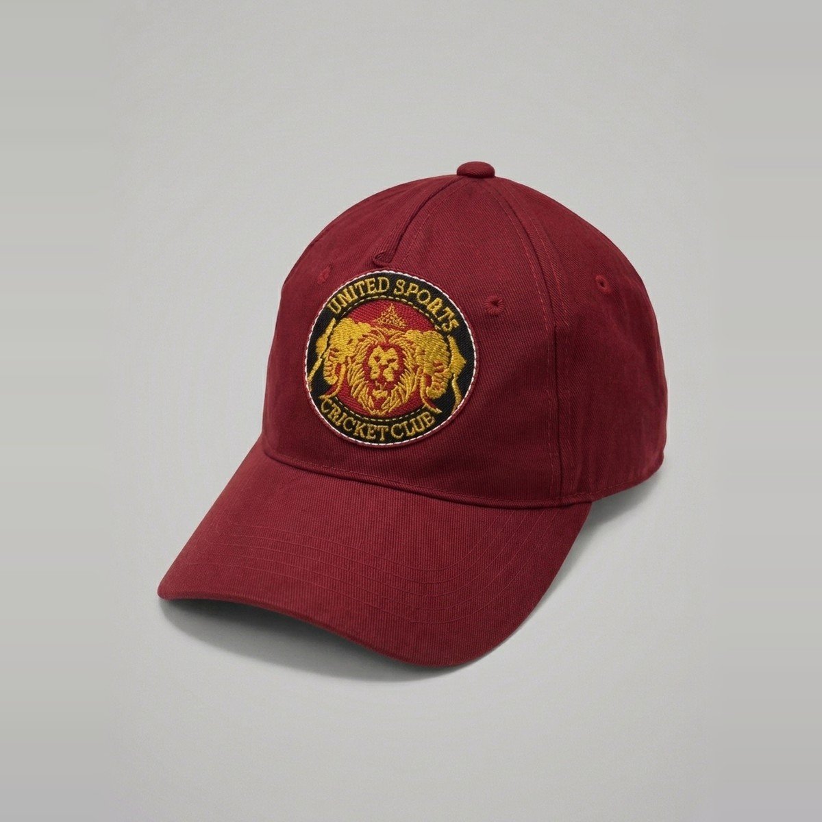 United Sports Cricket Club cap in club maroon with embroidered crest
